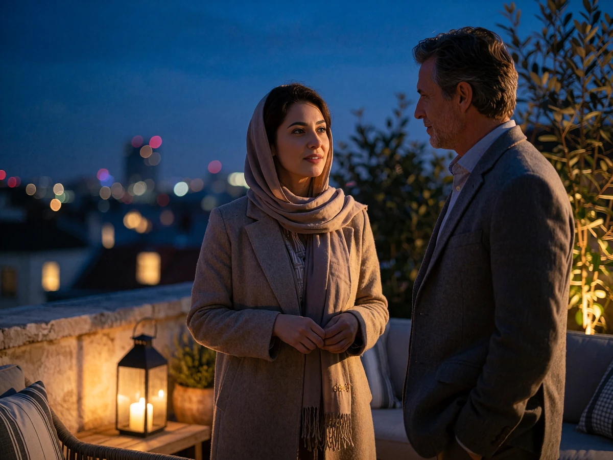 Afghan woman in a modest coat and Western man in relaxed conversation on a quiet rooftop lounge at dusk